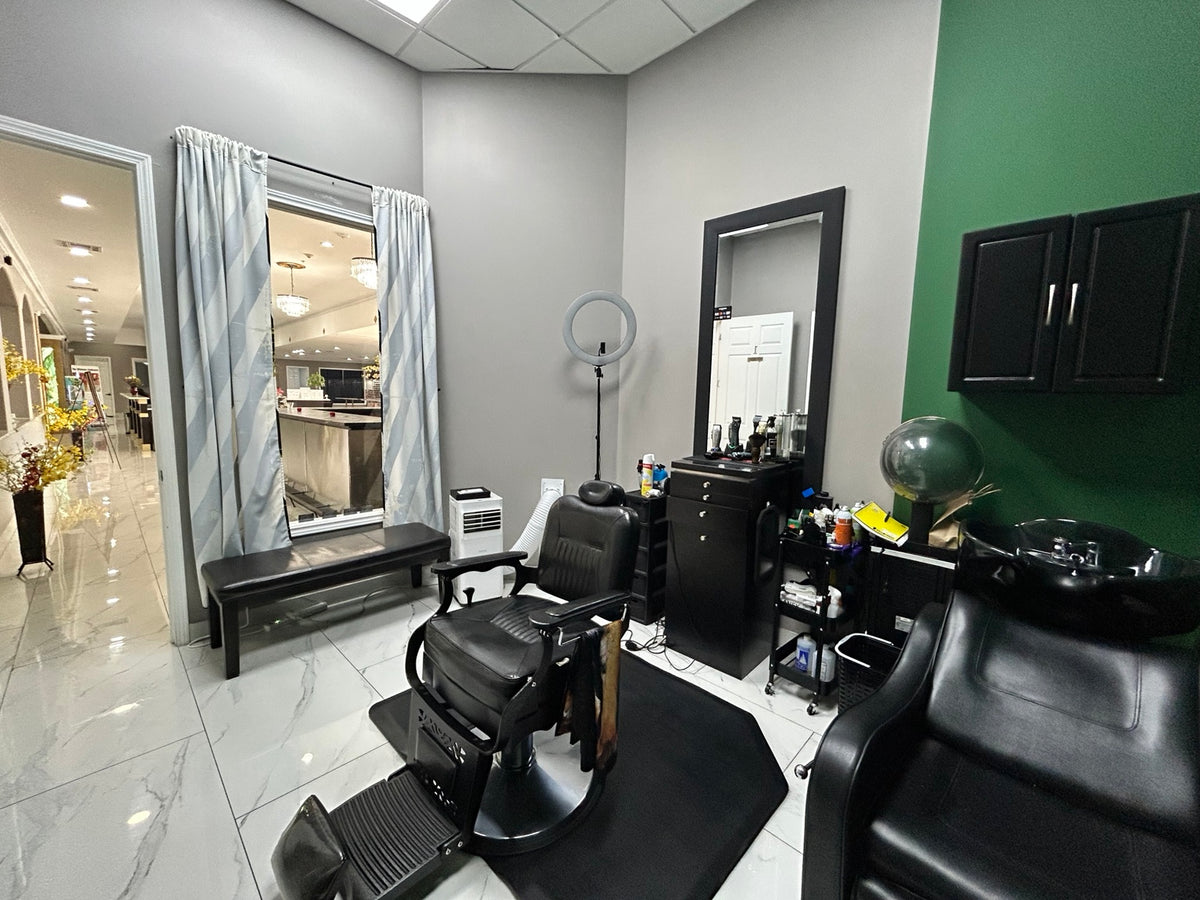 Inside Under The Radar Barber Studio private suite with barber chair and green wall