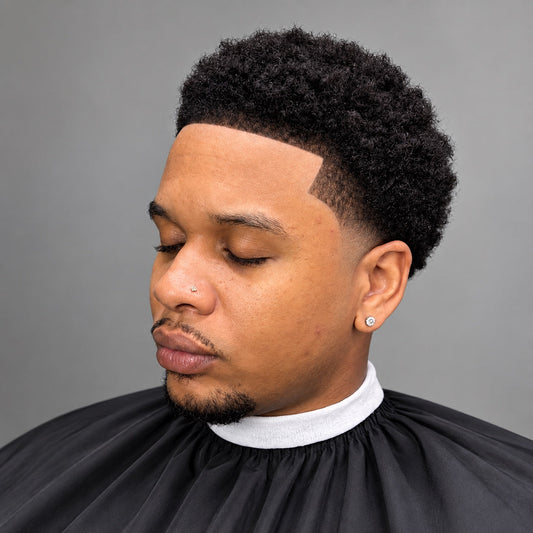 Fresh curly haircut with a crisp line-up and tapered sides at Under The Radar Barber Studio